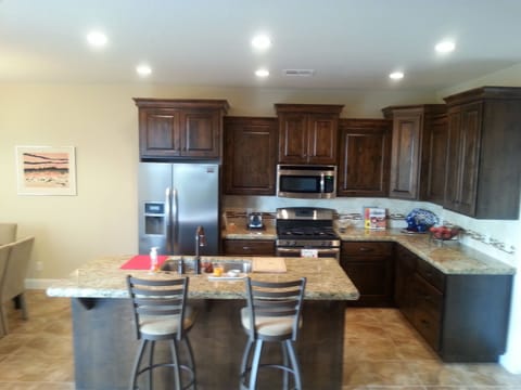 Large kitchen with stainless steel appliances. Large pantry room to right of pic