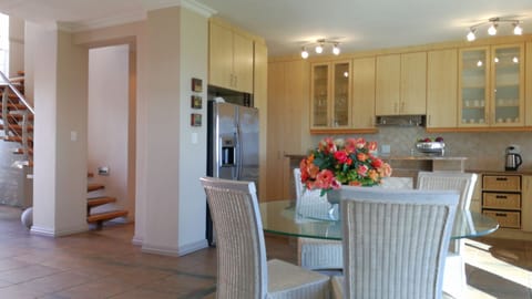 Kitchen with main entrance to left and right is stunning views over lawn