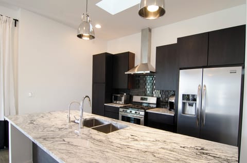 Well stocked kitchen designed for feeding a large group.  Granite. Stainless. 