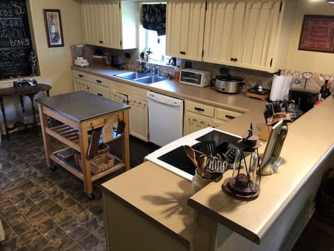 The big country kitchen is stocked with all the appliances and utensils your crew will need for a delicious home-cooked meal!