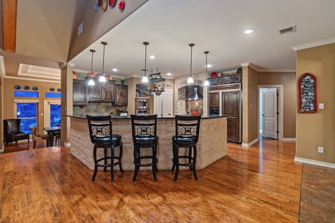 View of large kitchen island.  5 barstools available.
