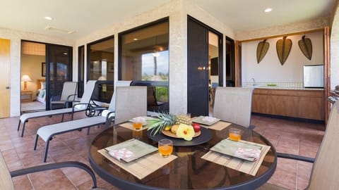 Spacious, covered lanai with glass table and loungers