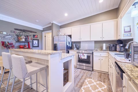 Full kitchen with door to the left of the entrance to 2 back bedrooms.