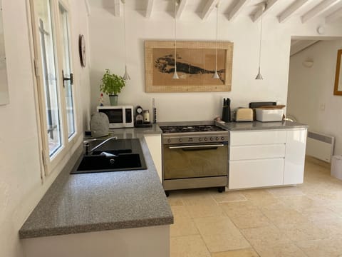 Kitchen - Access to terrace with chairs. Dualit appliances & Nespresso machine.