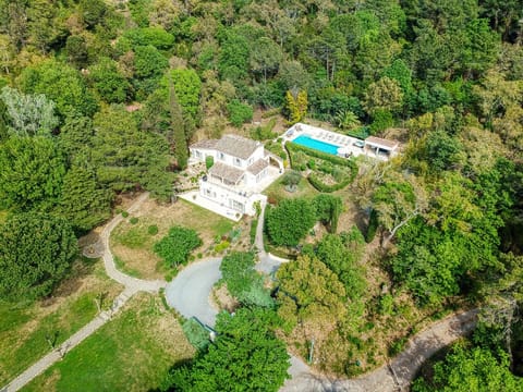 Ariel view of the villa showing its extensive grounds nestled within woodland.