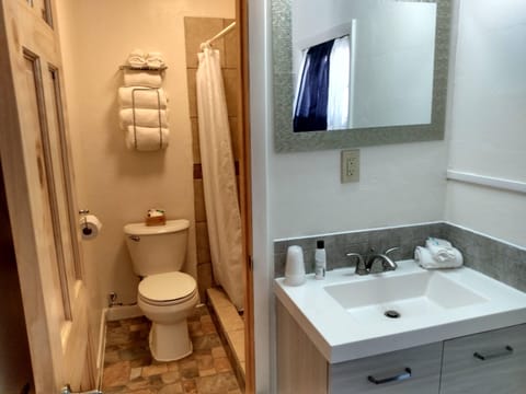 Basic Double Room, 2 Queen Beds, Non Smoking | Bathroom | Combined shower/tub, towels