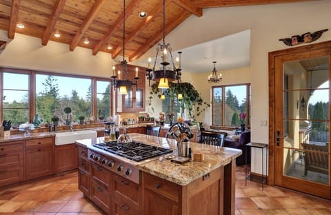Chef's kitchen with sunroom & French door leading to large slate covered patio.