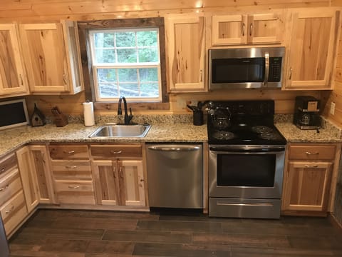 Full kitchen with granite counters, dishwasher and ice maker
