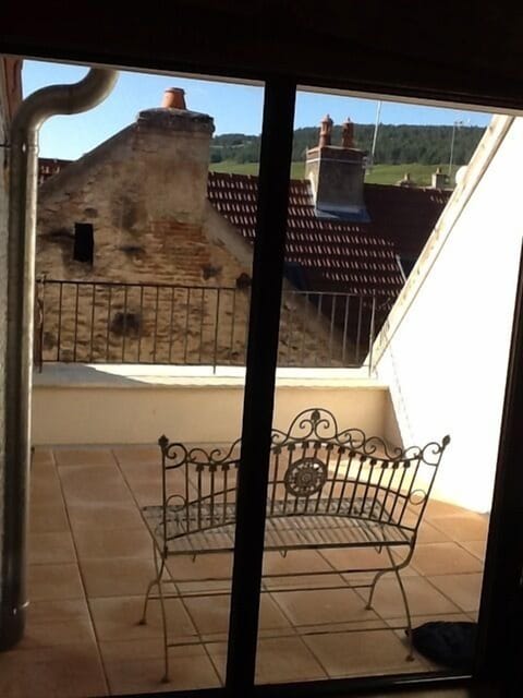 Private rooftop terrace bathed in afternoon sunshine.