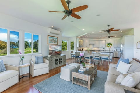 Open-concept living and dining area with serene golf course views and plenty of space for entertaining or family time.