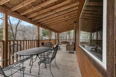 Front deck with swing, couch, and outdoor dining table for 4