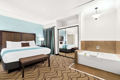 Suite, 1 King Bed, Jetted Tub, Corner | 1 bedroom, premium bedding, in-room safe, desk