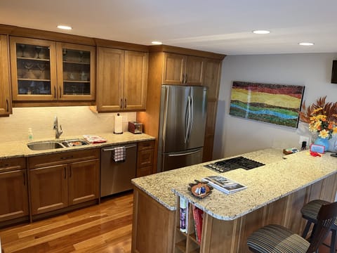 Spacious kitchen with granite countertops and a gas stovetop.