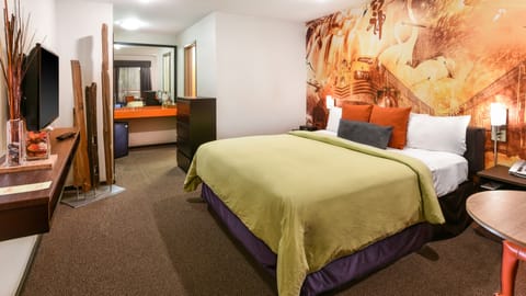 Standard Room, 1 King Bed | Living room | 32-inch LCD TV with satellite channels, TV, iPod dock