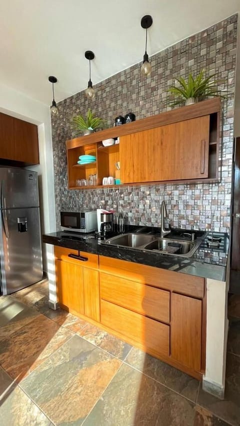 Comfort Penthouse | Private kitchen | Fridge, coffee/tea maker, highchair, paper towels