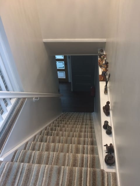 Staircase to exit , not necessary to go through other rooms.