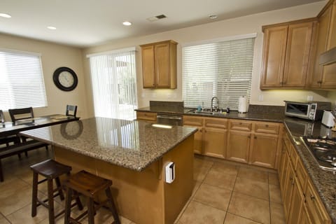 Large, fully stocked kitchen with island and stainless appliances