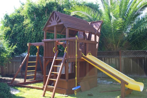 great play structure, slide, ladder, monkey bars, swings, 12 foot climbing wall