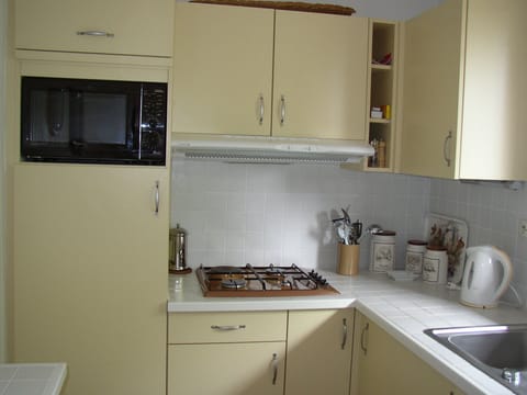 combi-microwave oven over fridge.  Hob to right.  1 electric and 3 gas