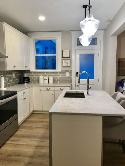 Kitchen with island that seats two and opens to dining area