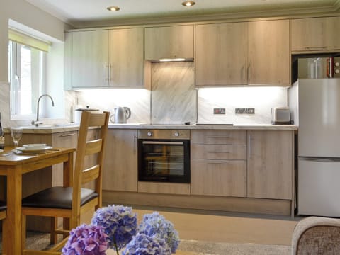 Modern fitted kitchen within the open-plan design | Jose’s at the Grange - Grange Country House Holiday Cottages, Loweswater, near Cockermouth