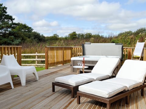 Extended decking areas with loungers and hot tub | Eagle Owl Lodge, St Columb Major, near Padstow