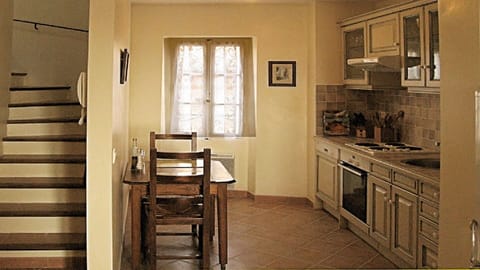 Kitchen, Breakfast Table, Window over Old Village and Stairs to Bedrooms & Bath