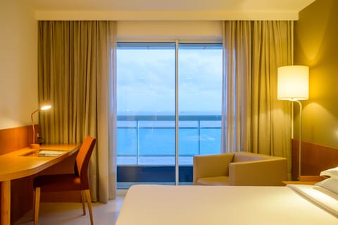 Junior Suite, Sea View | Minibar, in-room safe, desk, blackout drapes