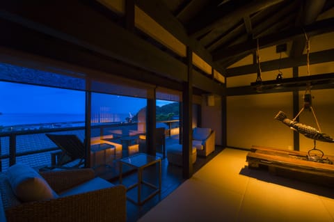 Japanese Western Style Room with Private Open-air Bath, Ocean View | Living room | Flat-screen TV