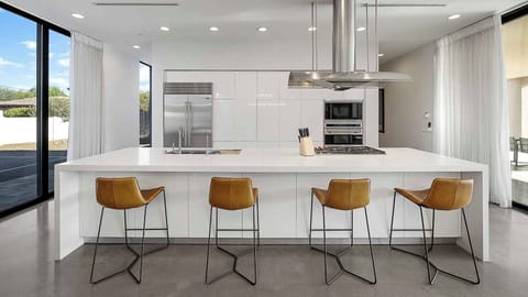 Sleek modern kitchen with a spacious island and stylish barstools.