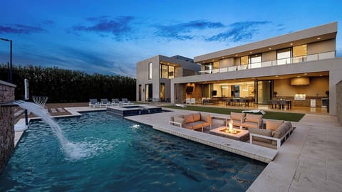 Modern backyard with a pool, fire pit, and dining for ultimate outdoor luxury.