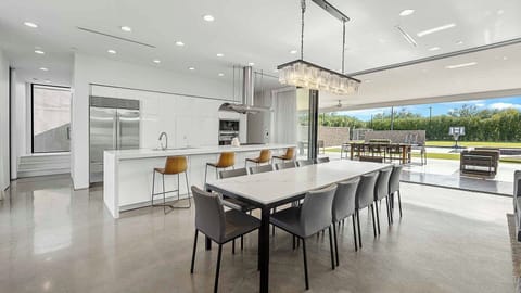 Bright modern kitchen with seamless indoor-outdoor dining.