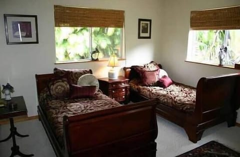 The 2nd guest house bedroom has twin beds and a full bathroom, with tub & shower