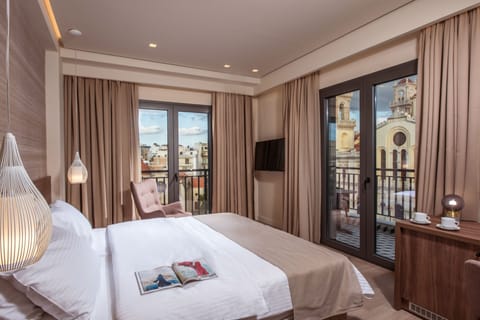 Deluxe Room with Balcony and City View | Minibar, in-room safe, individually decorated, individually furnished