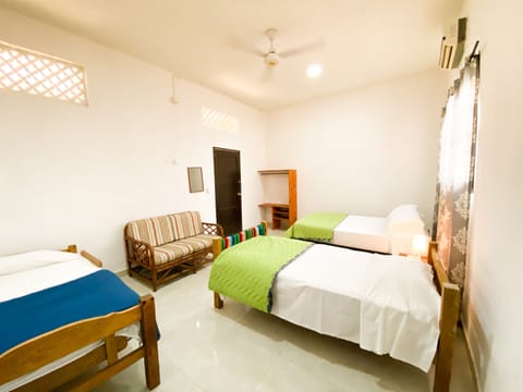 Economy Quadruple Room, Private Bathroom, Courtyard Area | Minibar, iron/ironing board, free WiFi, bed sheets