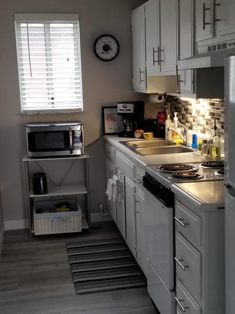 Full kitchen with stove, oven, microwave, refrigerator, coffee station, toaster.