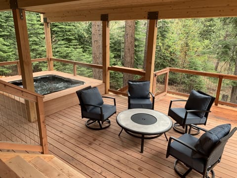 Lower deck with Bullfrog hot tub and comfy lounge area- (not a fire pit)