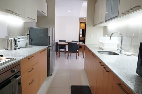 One Pacific Residences 2A | Private kitchen | Full-size fridge, microwave, stovetop, rice cooker