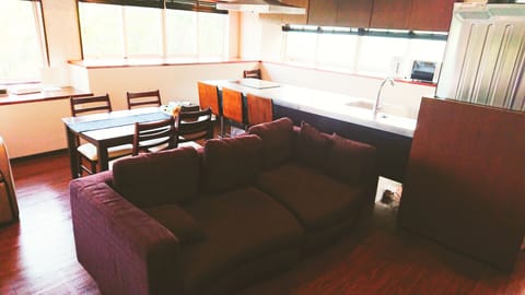 Family Quadruple Room | Living area | 55-inch flat-screen TV with satellite channels, TV, DVD player