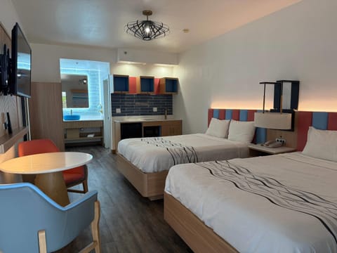 Suite, 2 Queen Beds, Non Smoking | Desk, laptop workspace, blackout drapes, iron/ironing board