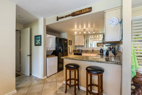 Kitchen with dish washer, old washer/dryer, full range oven & casual barstools