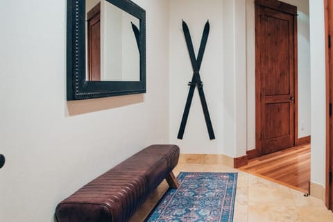 Entryway bench and entry closet with lots of hooks and room for everyone's gear