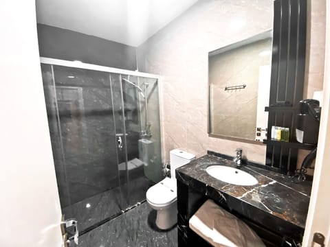 Economy Room, No Windows, Basement | Bathroom | Shower, rainfall showerhead, hair dryer, slippers