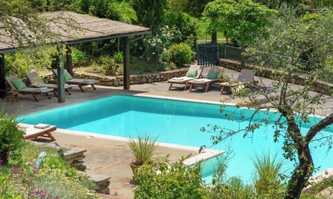 Our infinity pool with outdoor furniture and a patio for shade.  All fenced