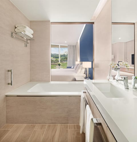 Deep soaking tub, rainfall showerhead, designer toiletries, hair dryer