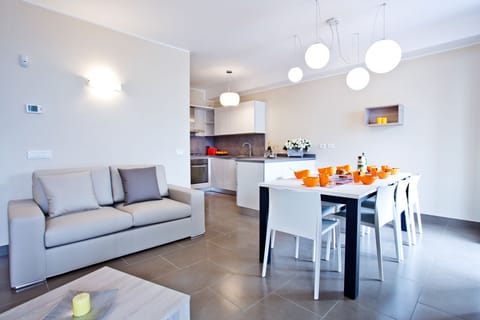 Open plan luxury living featuring modern kitchen and dining for eight.
