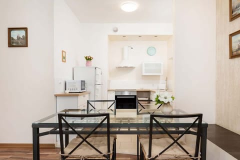 A dining area with a wooden table and black chairs, suitable for casual or formal dining.
