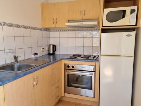 One Bedroom Apartment | Private kitchen | Microwave, electric kettle, toaster, cleaning supplies