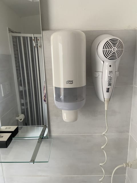 Shower, hair dryer, slippers, towels