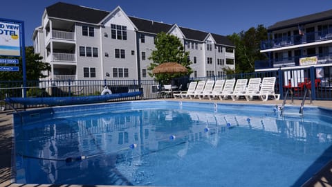 Seasonal outdoor pool, open 9:00 AM to 8:00 PM, pool umbrellas